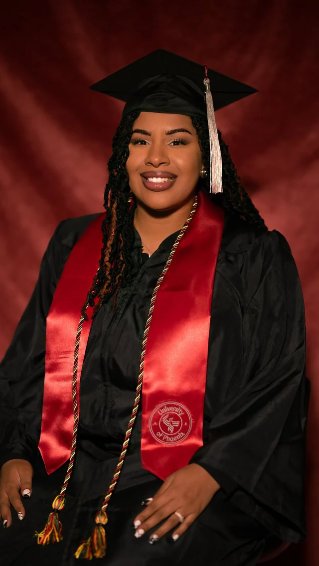 A graduation reel cover of Keira smiling in a black cap and gown with a red stole