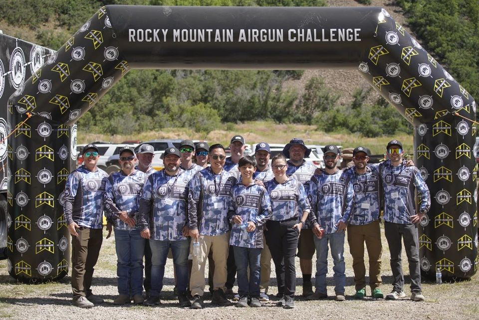 The Saber Tactical team stands beneath the Rocky Mountain Airgun Challenge event arch